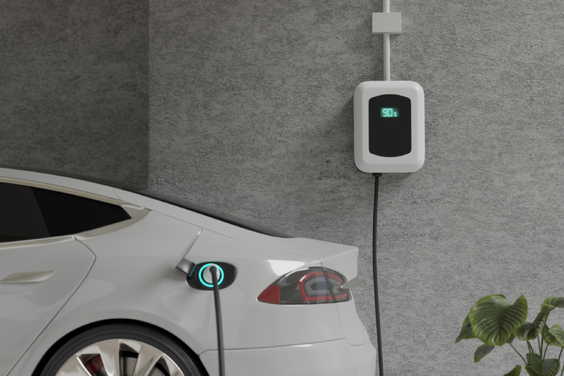 White Chevrolet EV vehicle charging in the garage of a resident's home during the day